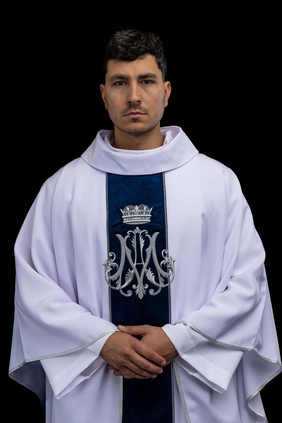 Front view of an Ecru Marian Chasuble Embroidered with a Silver Monogram with blue velvet orphrey