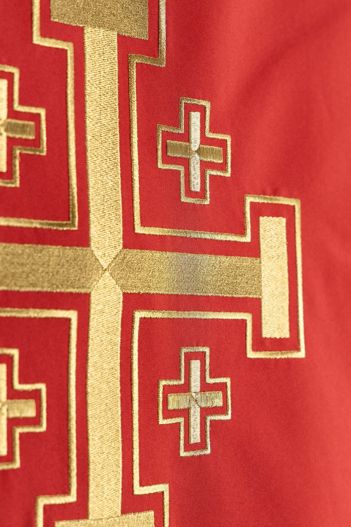 Close-up of the lectern cover showing small gold crosses within the Jerusalem cross embroidery