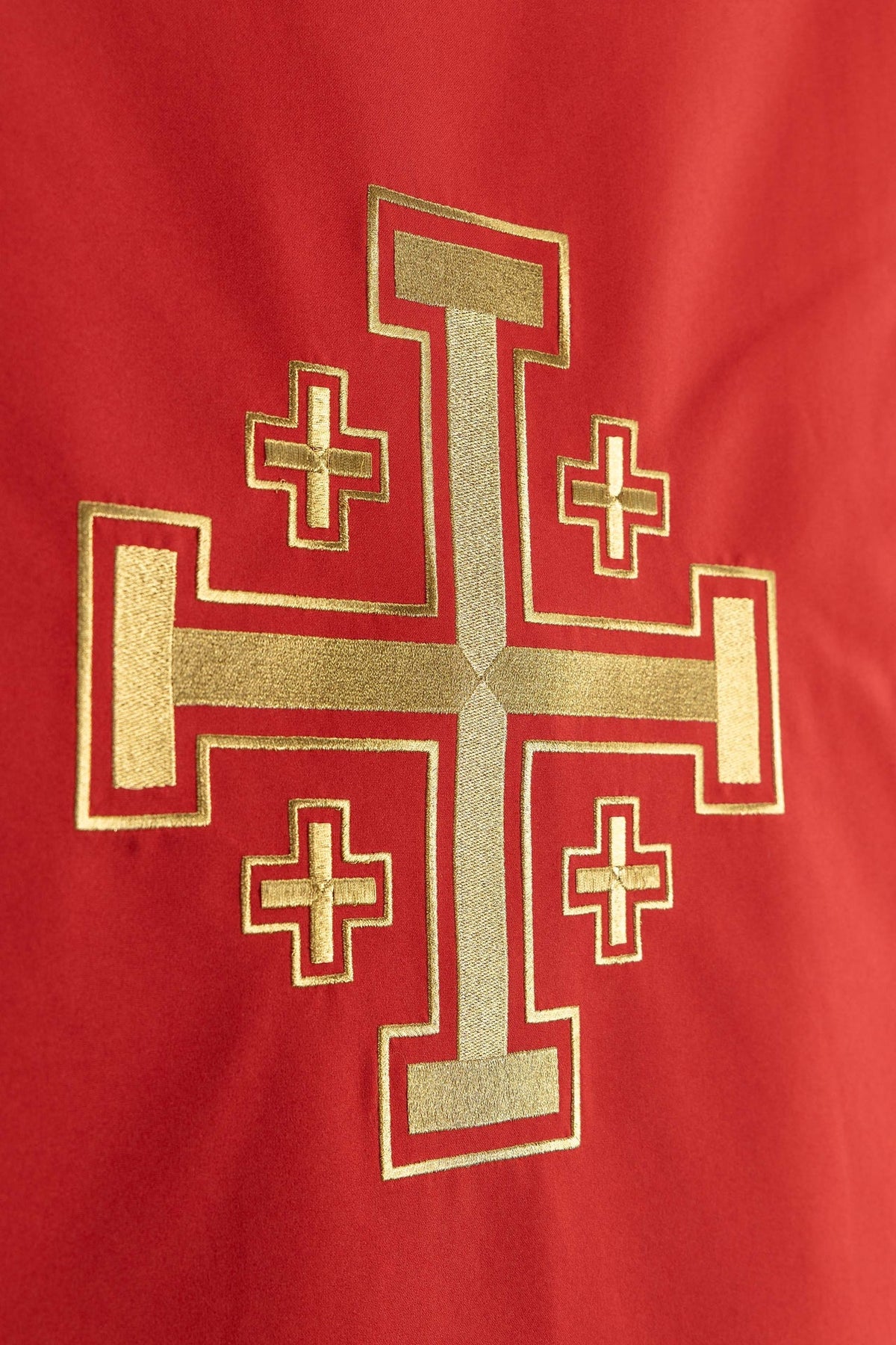 Close-up of the red lectern cover showing the full gold Jerusalem cross embroidery