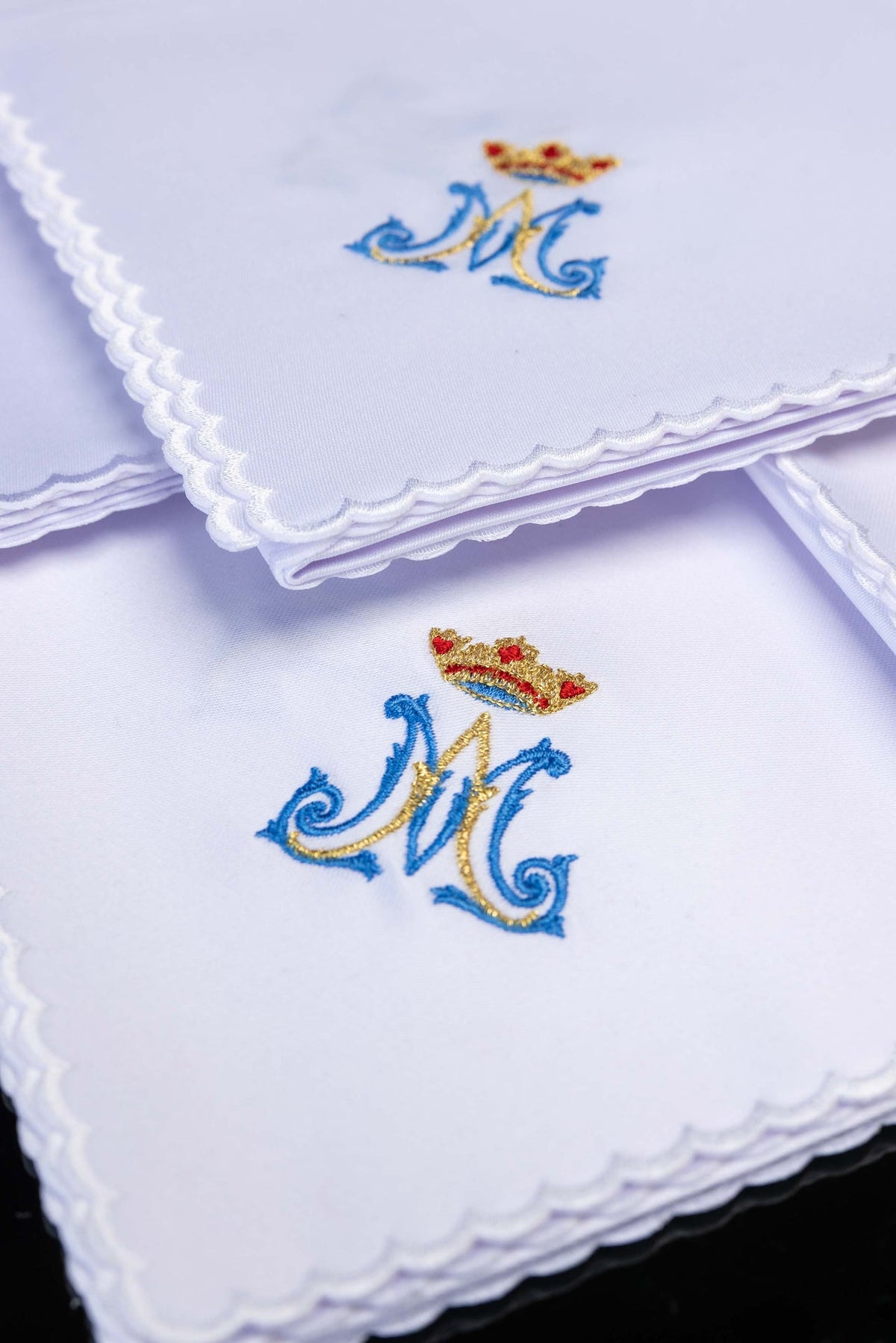 Close-up of the corporal set with white fabric, Marian monogram and crown embroidery