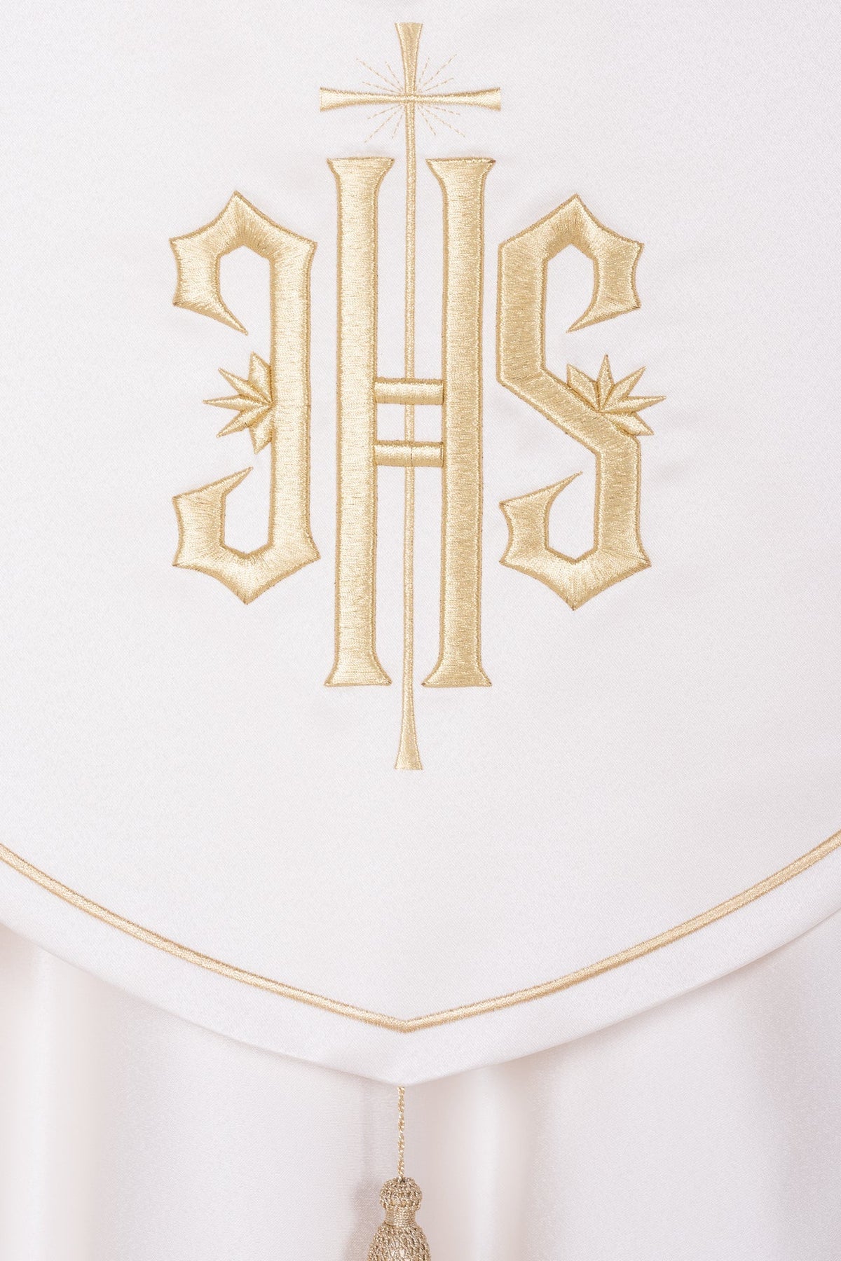 Back detail of ecru liturgical cope with embroidered gold cross and monogram