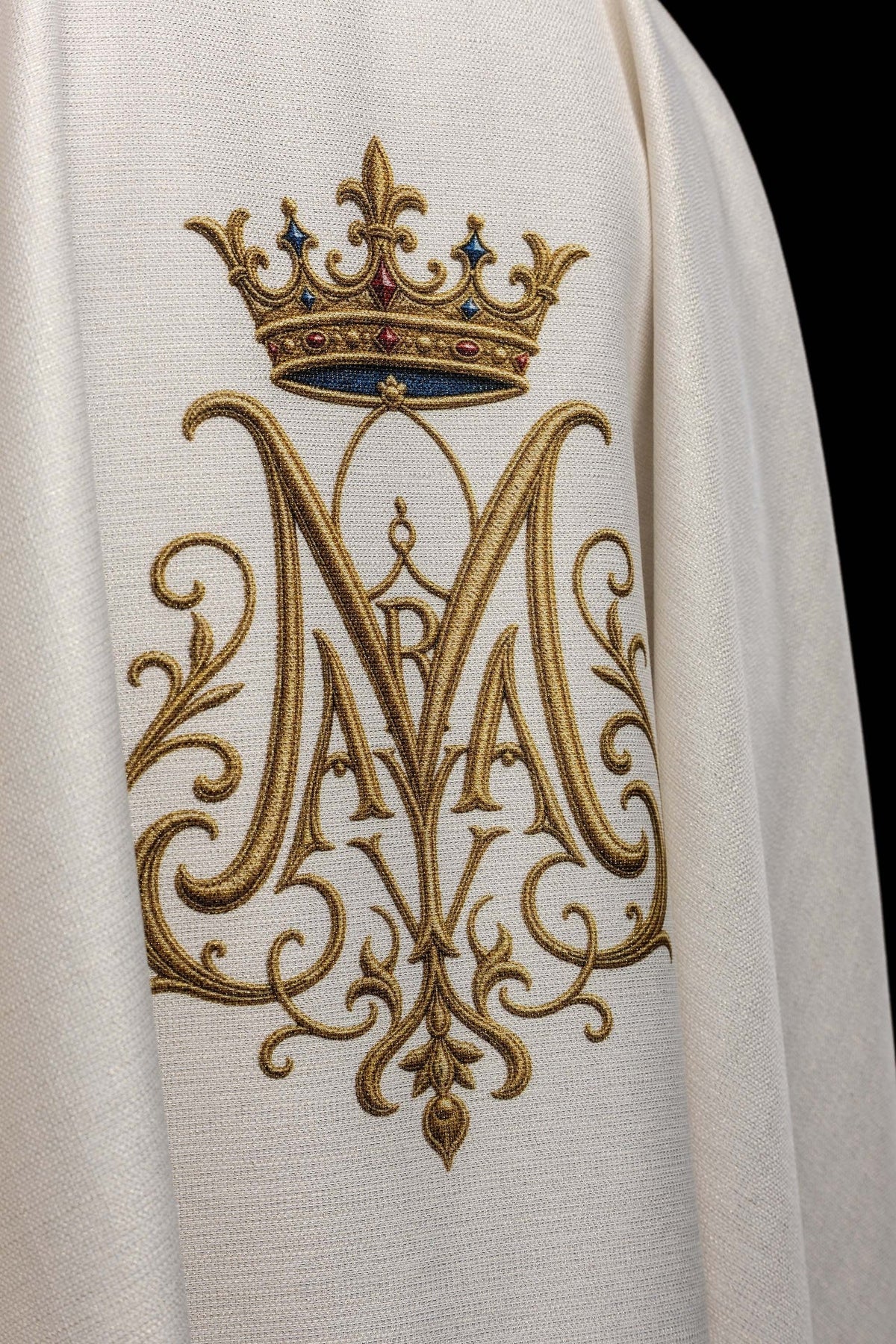 Close-up of the chasuble's embroidered crowned Marian monogram