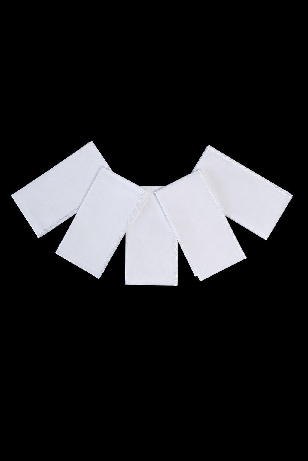 Front view of Lavabo Towel Set Finished with White Wavy Trim, showing multiple white towels