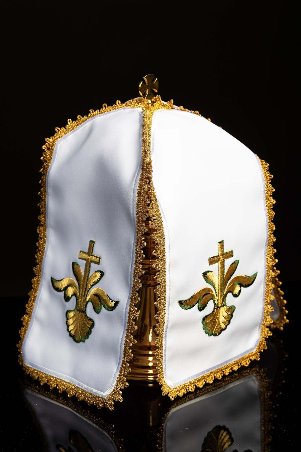 Front detail of the white ciborium veil showing gold trim, top cross and matching embroidery