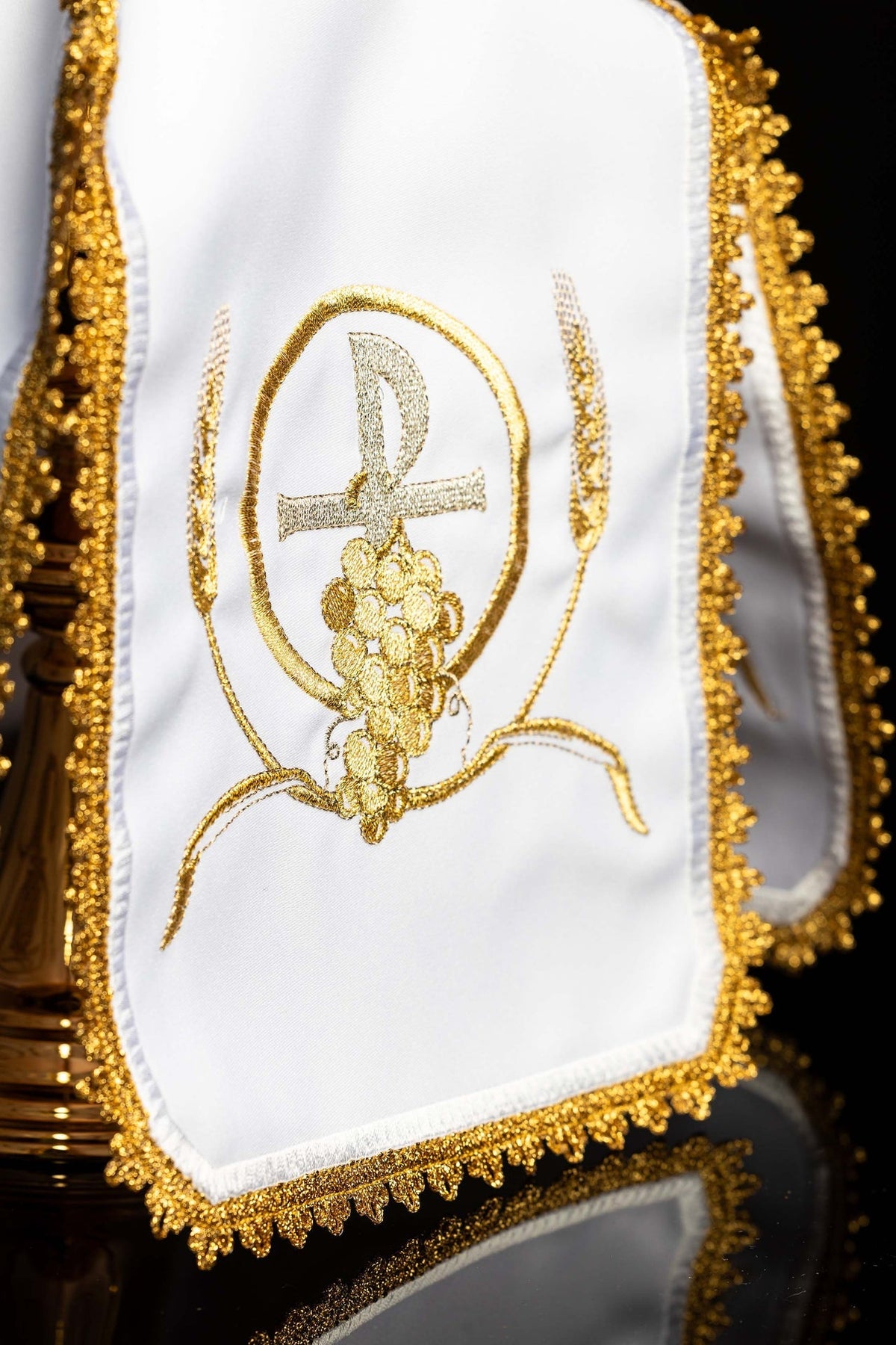 Close-up of white ciborium veil with gold PAX embroidery, grape cluster and ornate trim