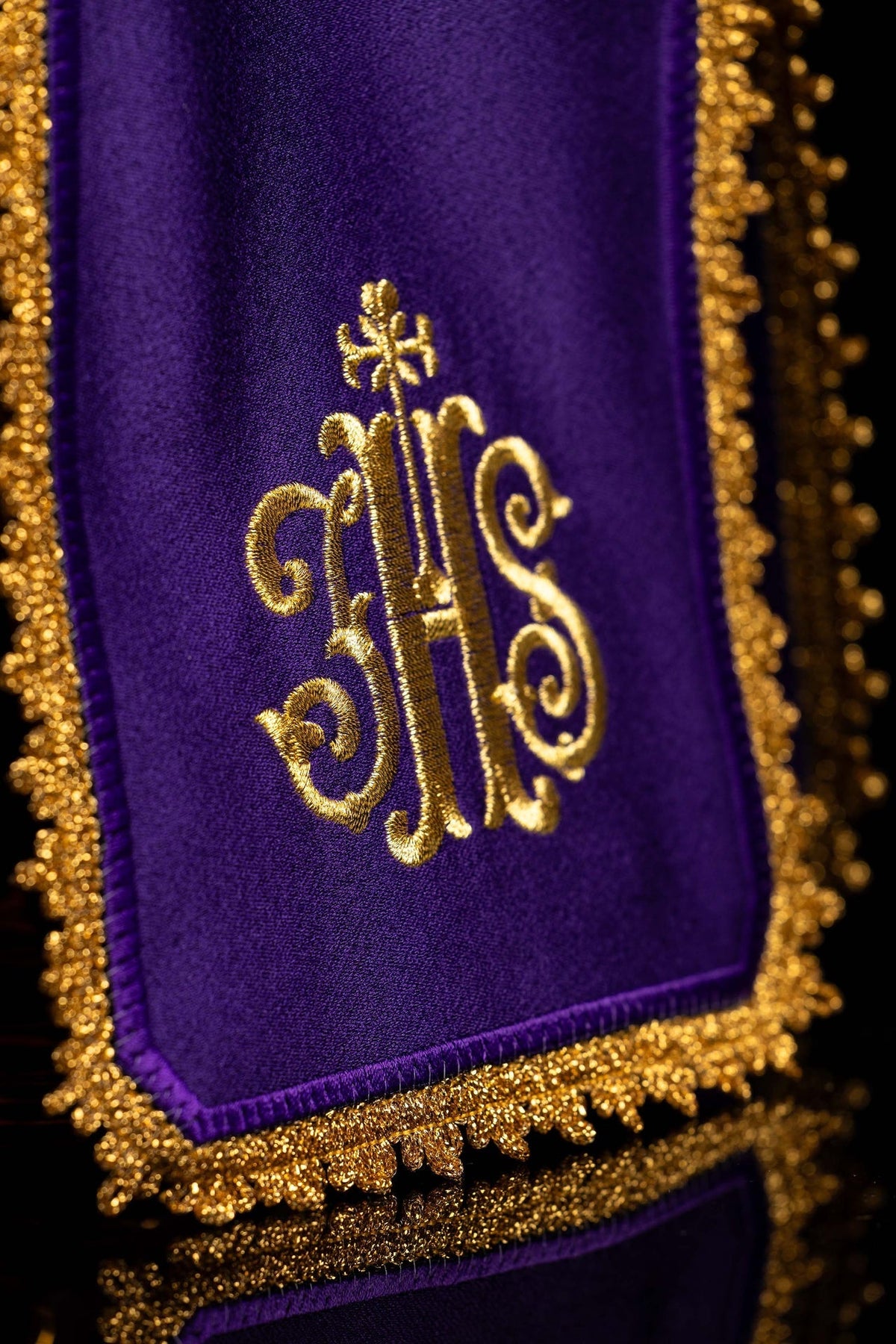 Close-up of the ciborium veil showing gold IHS embroidery and ornate gold edging