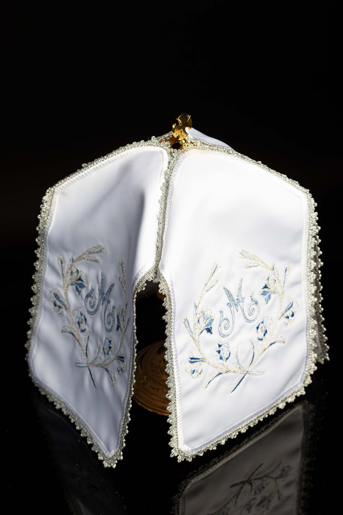 Open view of ciborium veil showing matching embroidered panels and silver trim