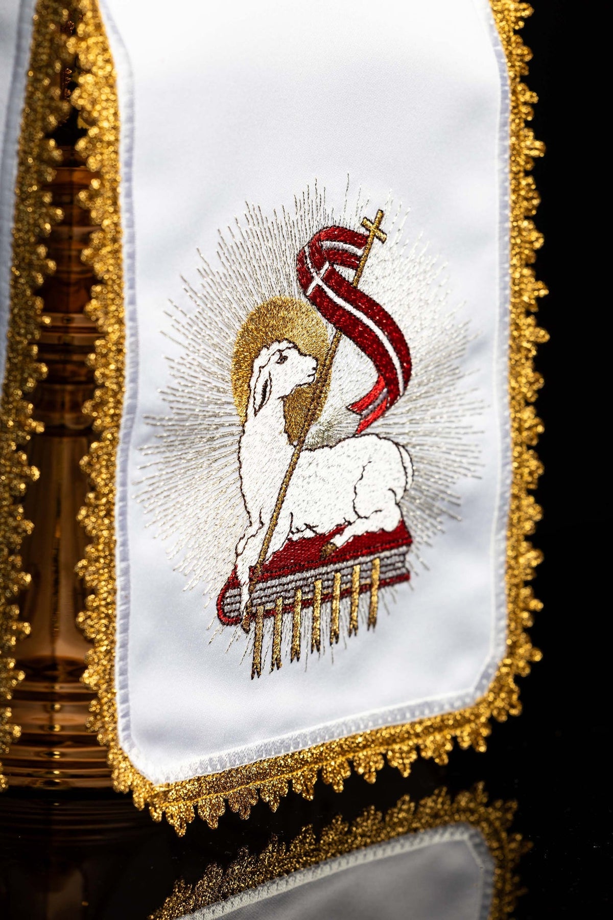 Close-up of the ciborium veil showing embroidered Paschal Lamb with red banner and gold fringe