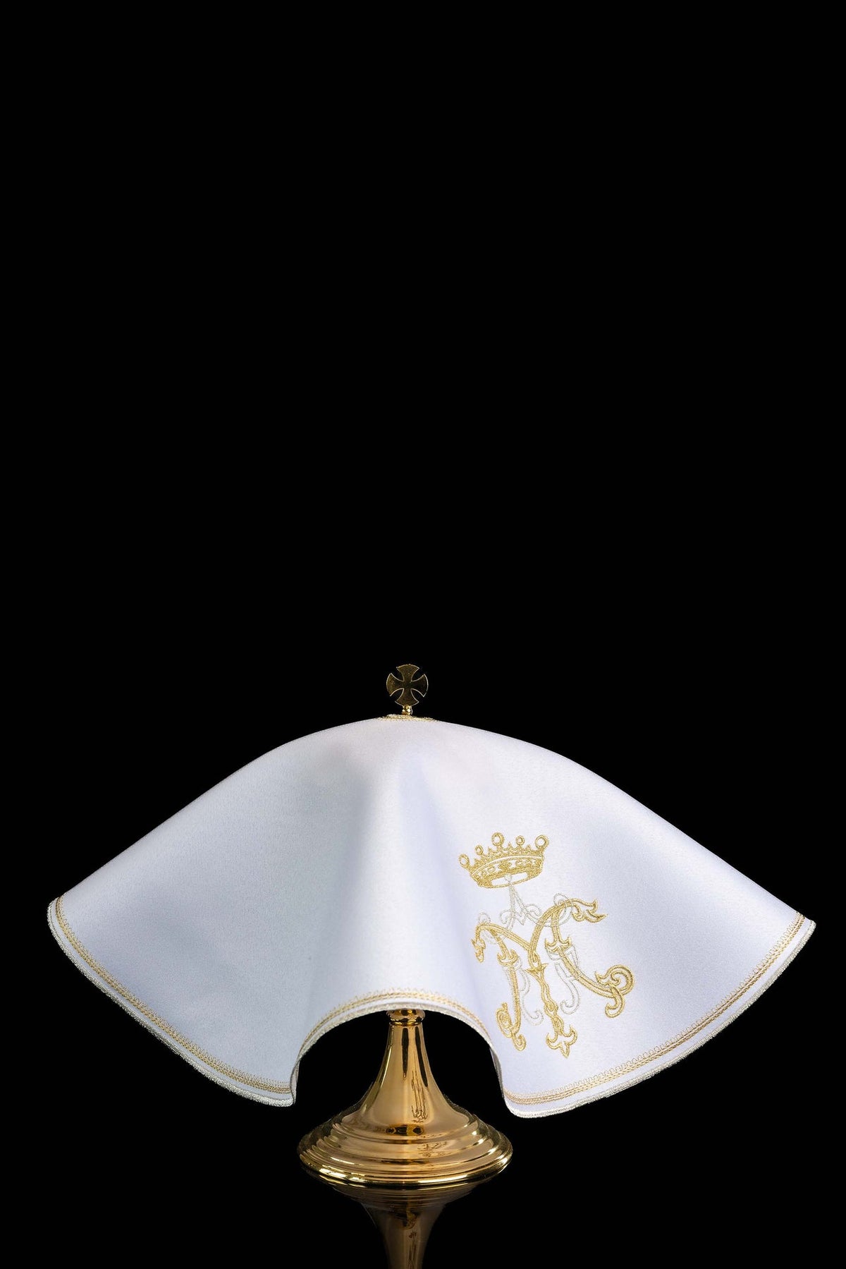 Side view of a white ciborium veil with gold Marian embroidery