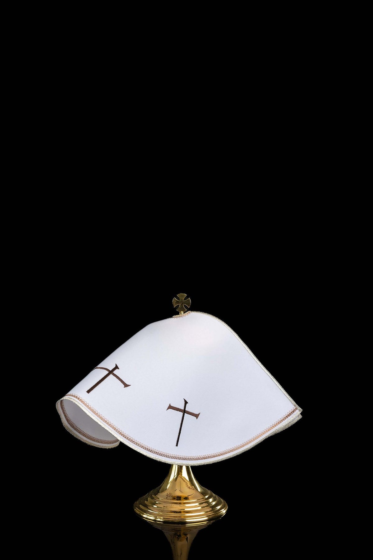 Side view of white ciborium veil with brown crosses and gold edging
