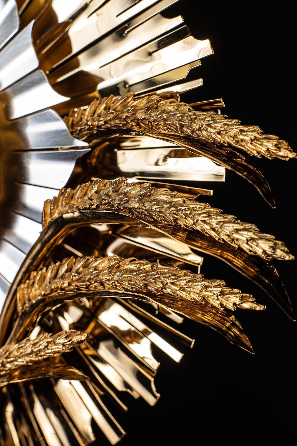 Close-up of gilded brass monstrance showing layered wheat-stem ornament