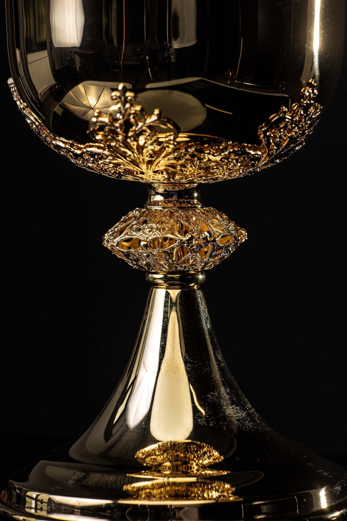 Lid detail of gilded brass ciborium with a round Eucharistic symbol