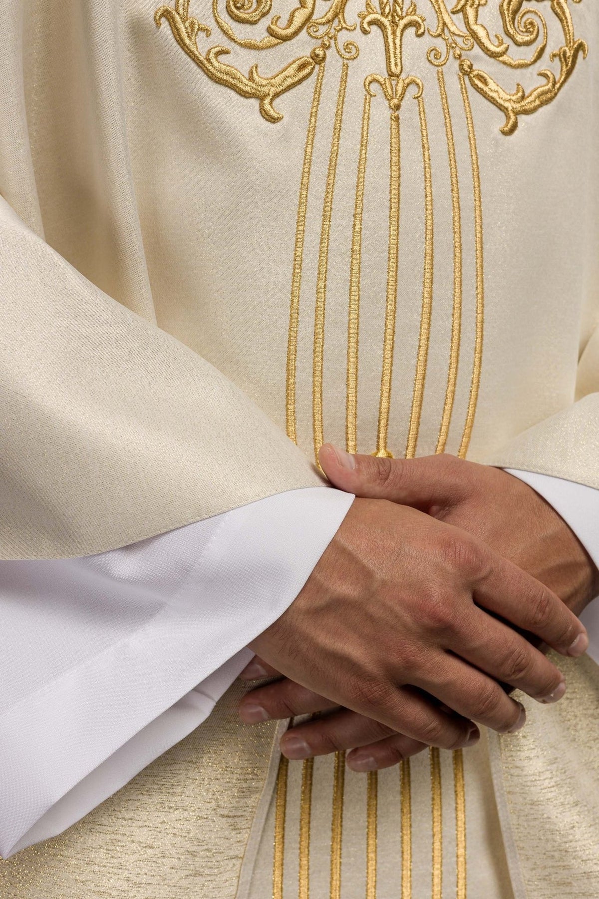 Close-up of the chasuble front with ornate gold embroidery and vertical lines