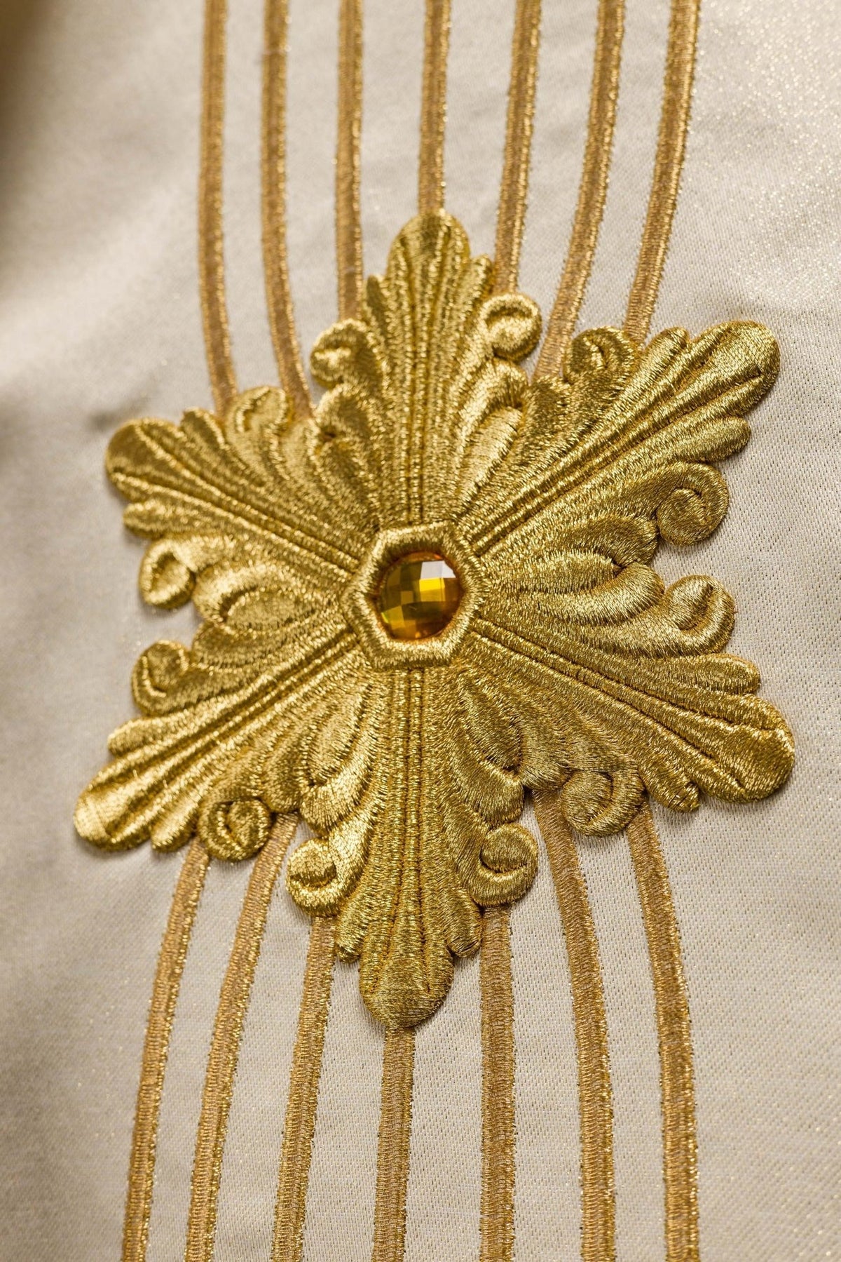 Back view of the chasuble with gold vertical embroidery and floral motifs
