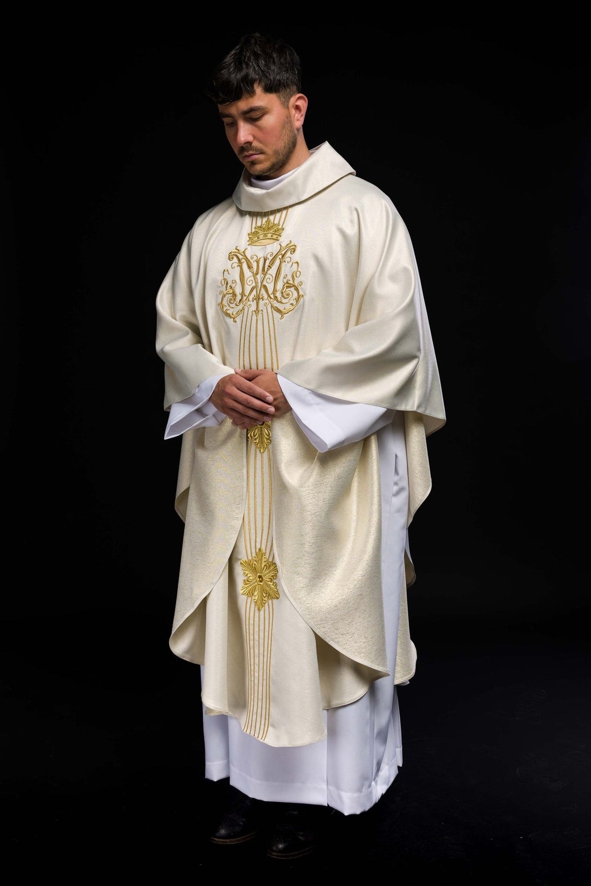 Three-quarter front view of the chasuble with gold crown and ornate embroidery