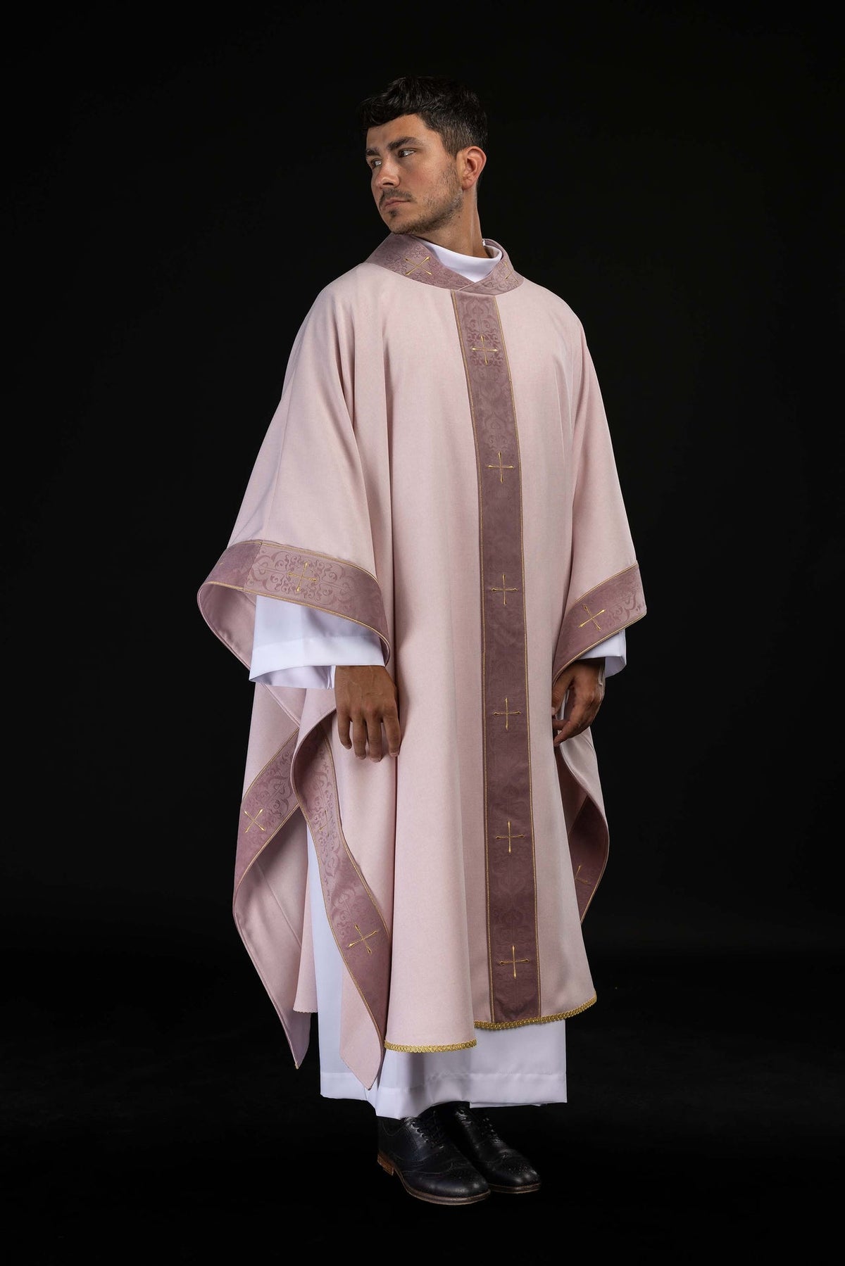 Side view of the rose chasuble with embroidered gold crosses on the orphrey