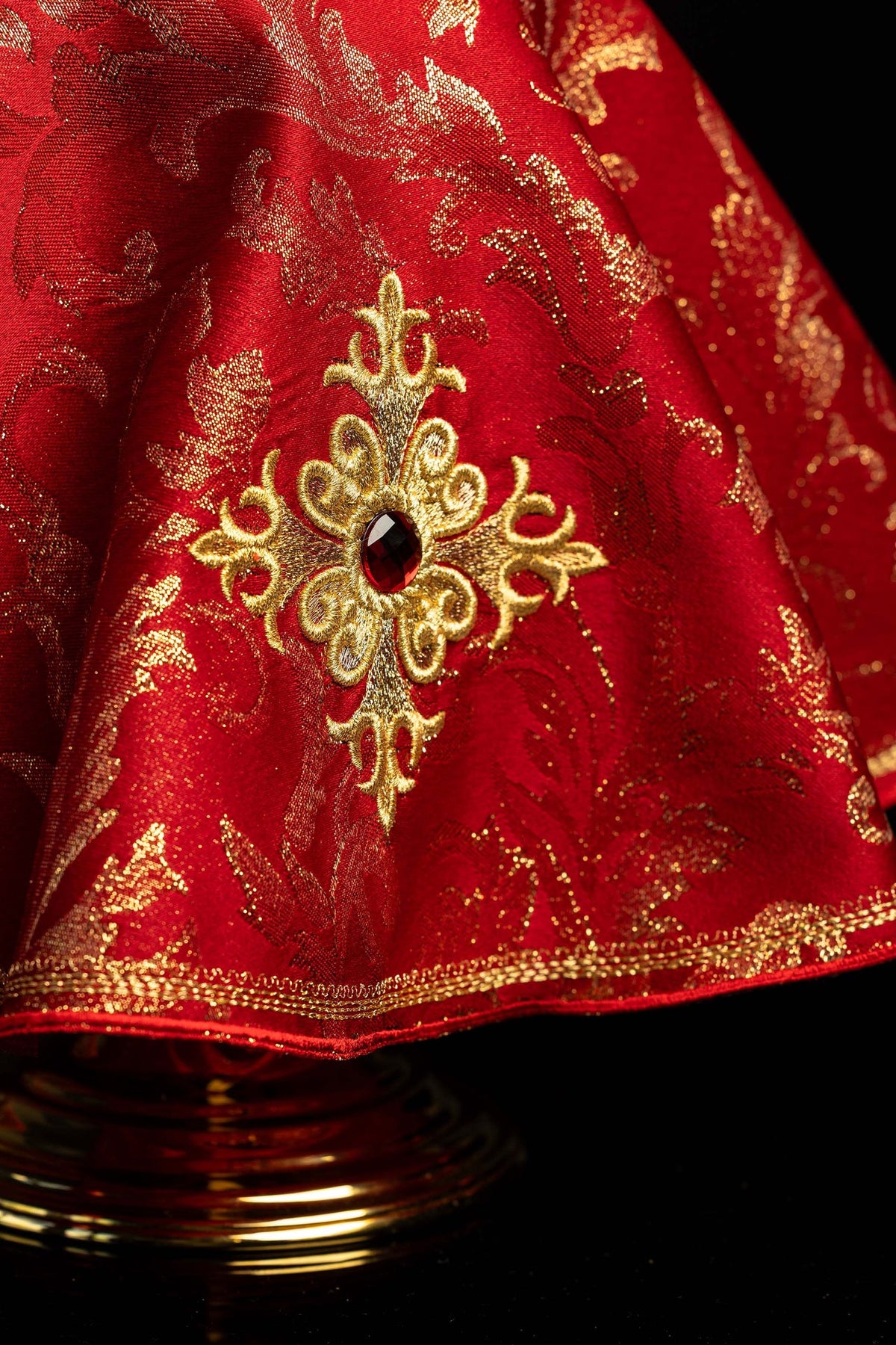 Close-up of the embroidered cross, red stone, and gold edging on the ciborium veil