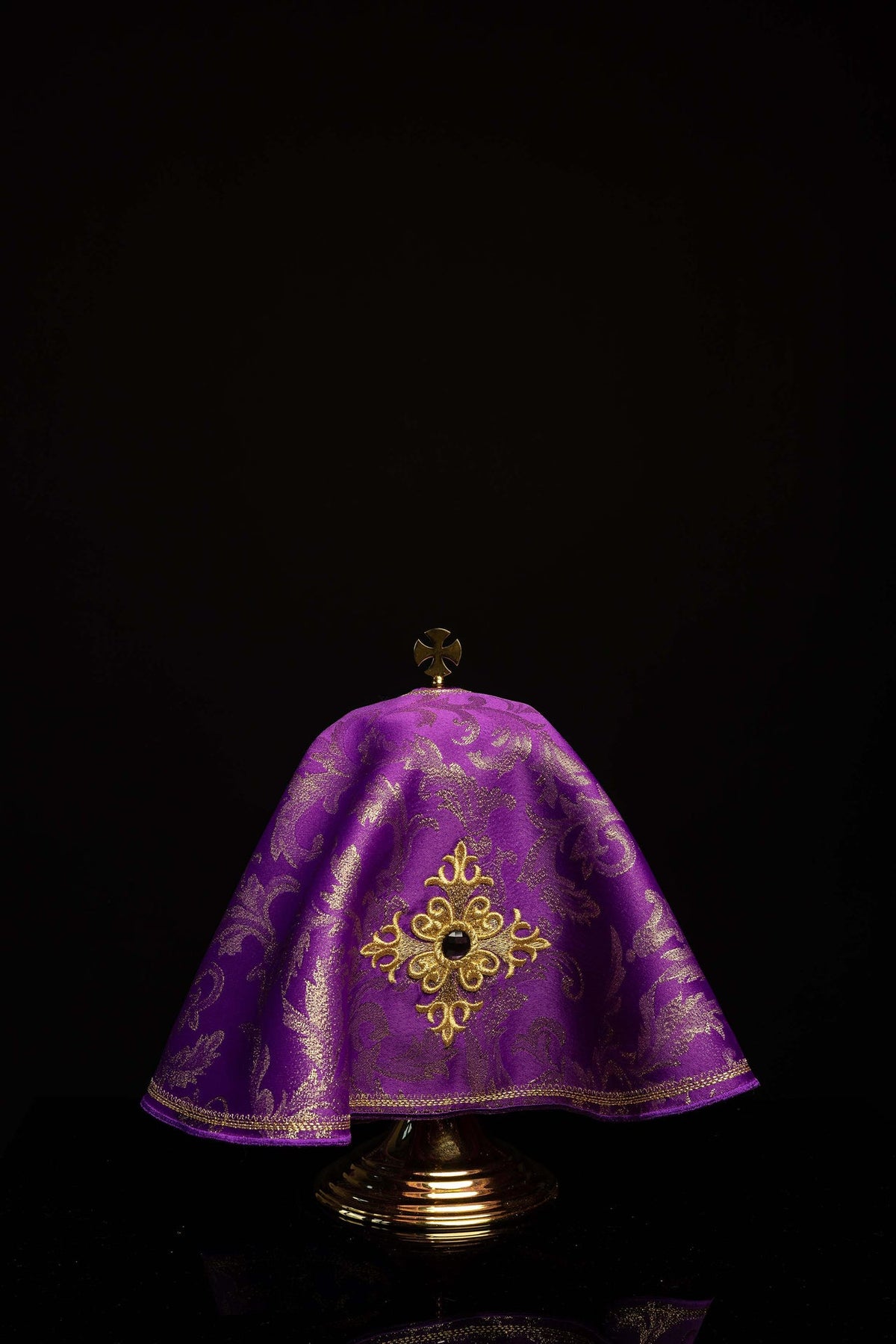 Full front view of the purple ciborium veil with gold border and embroidered cross