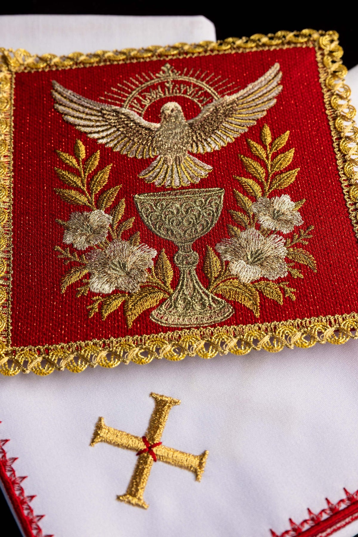Close-up of the altar linen set with embroidered Holy Spirit, Communion Chalice, flowers, and gold trim
