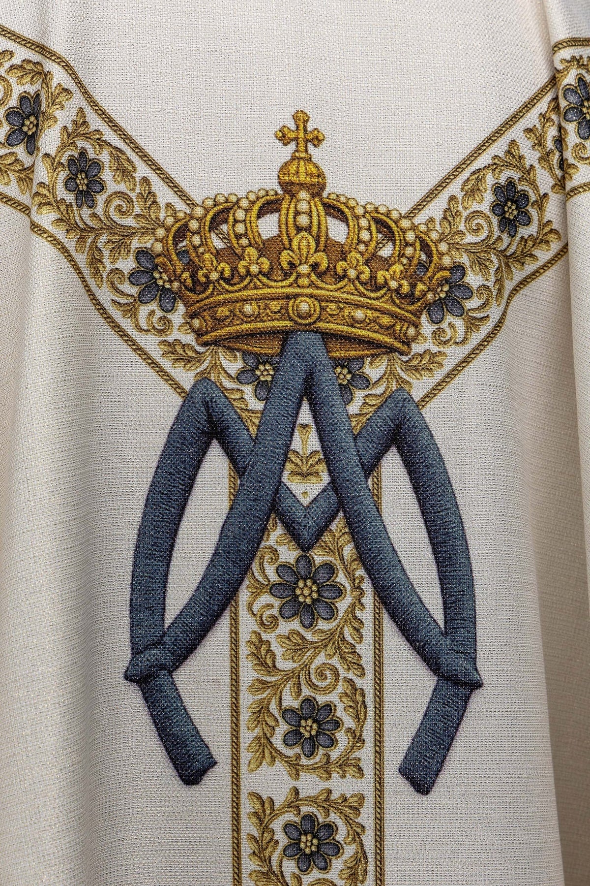 Detail of the chasuble back showing a crown and blue ribbons