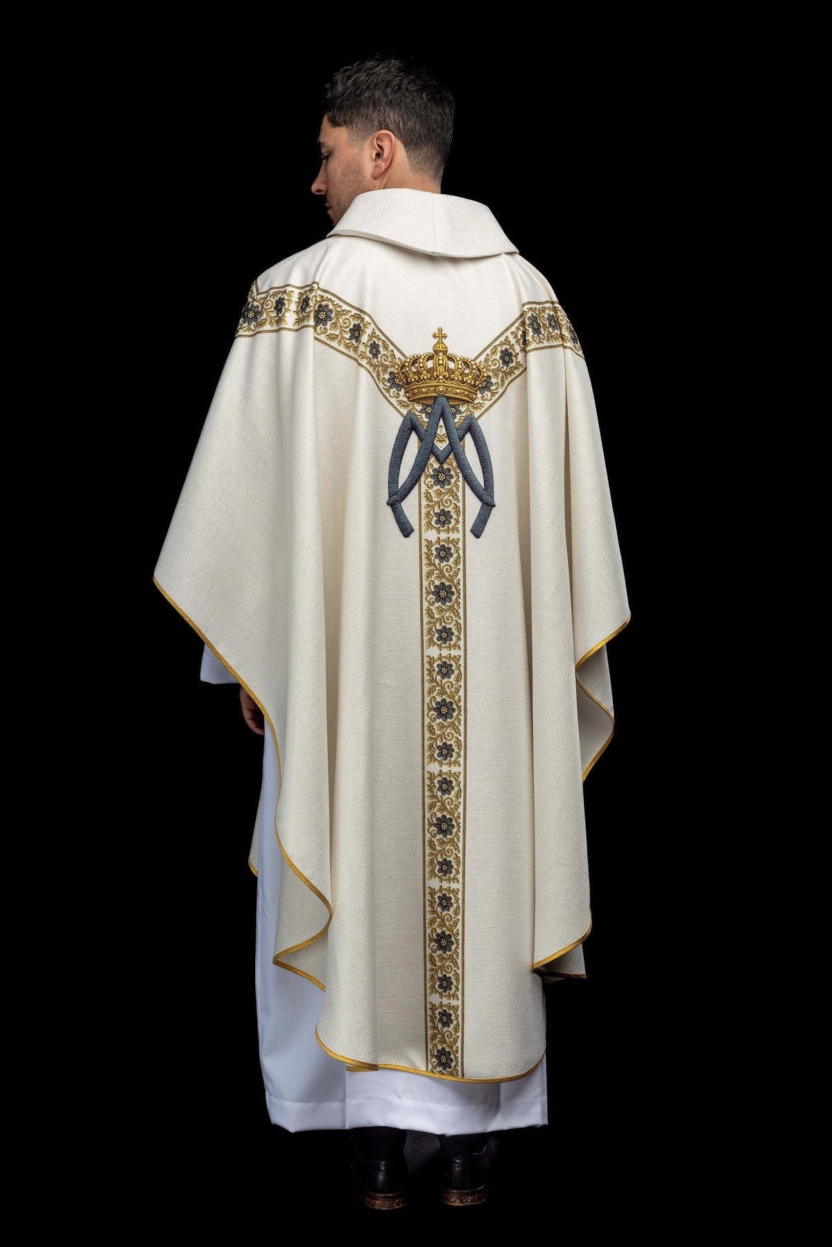 Back view of a printed chasuble with the image of Our Lady of Lourdes, showing a crowned Marian monogram