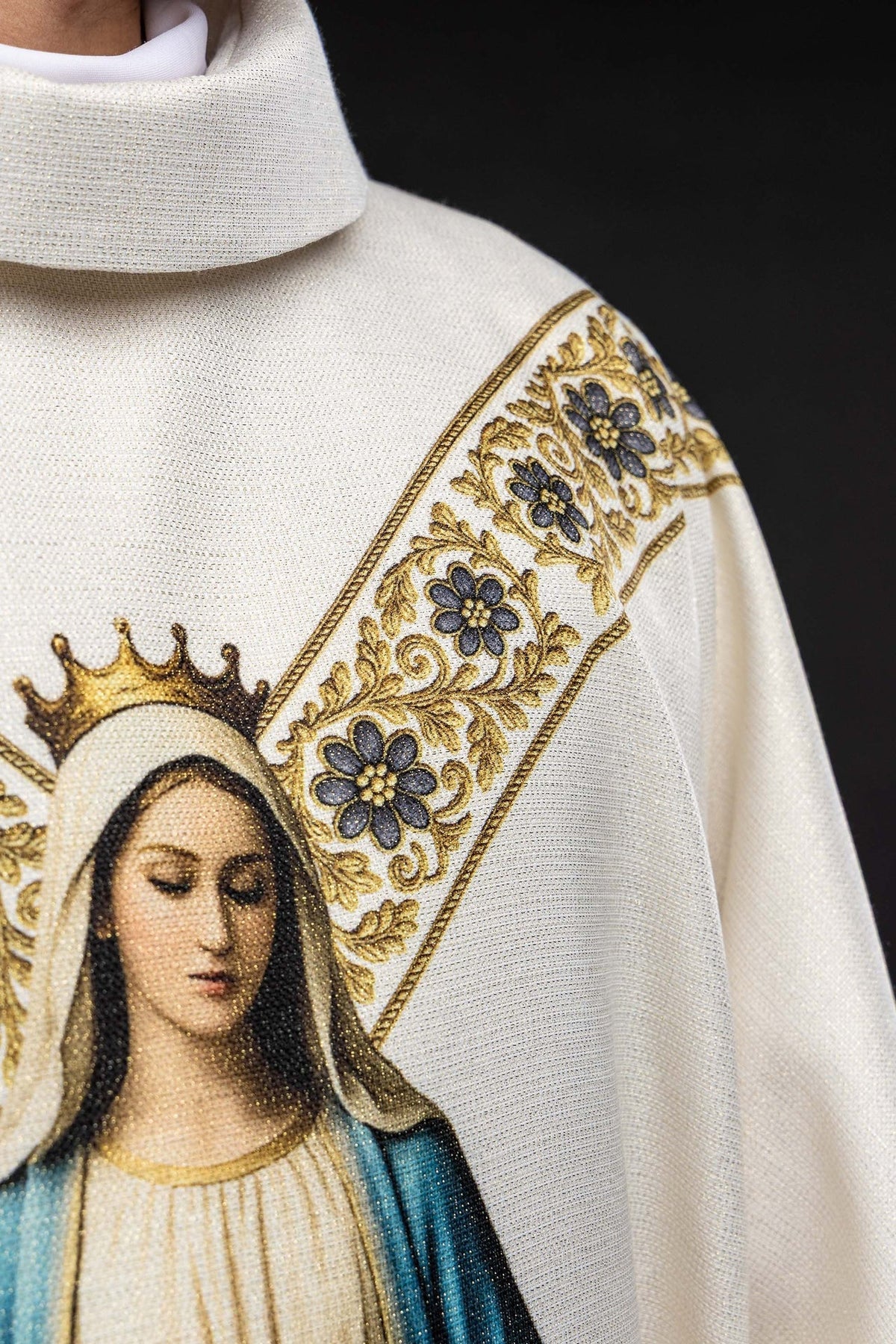 Close-up of the chasuble image and floral shoulder band in ecru, gold, and blue
