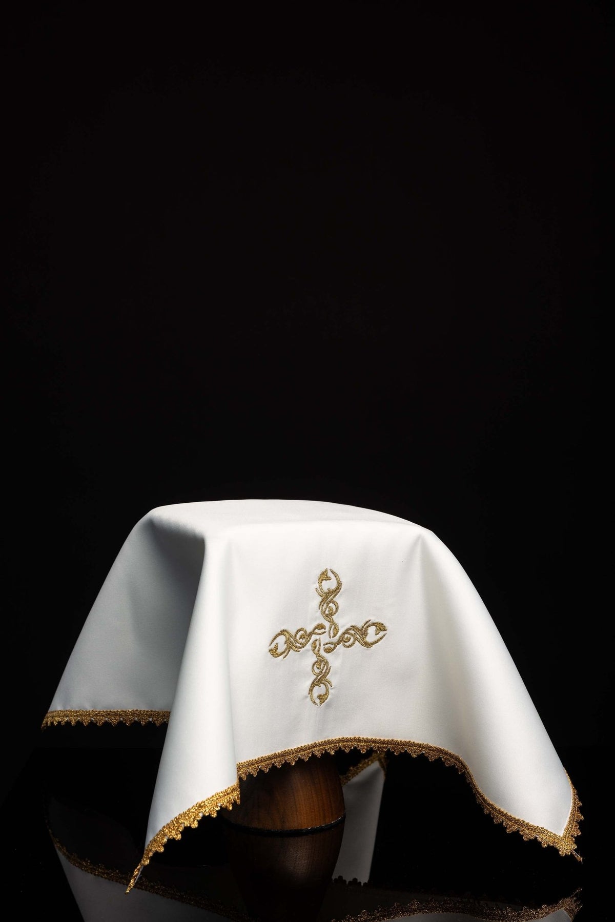 Draped white chalice veil with embroidered cross motif and gold trim