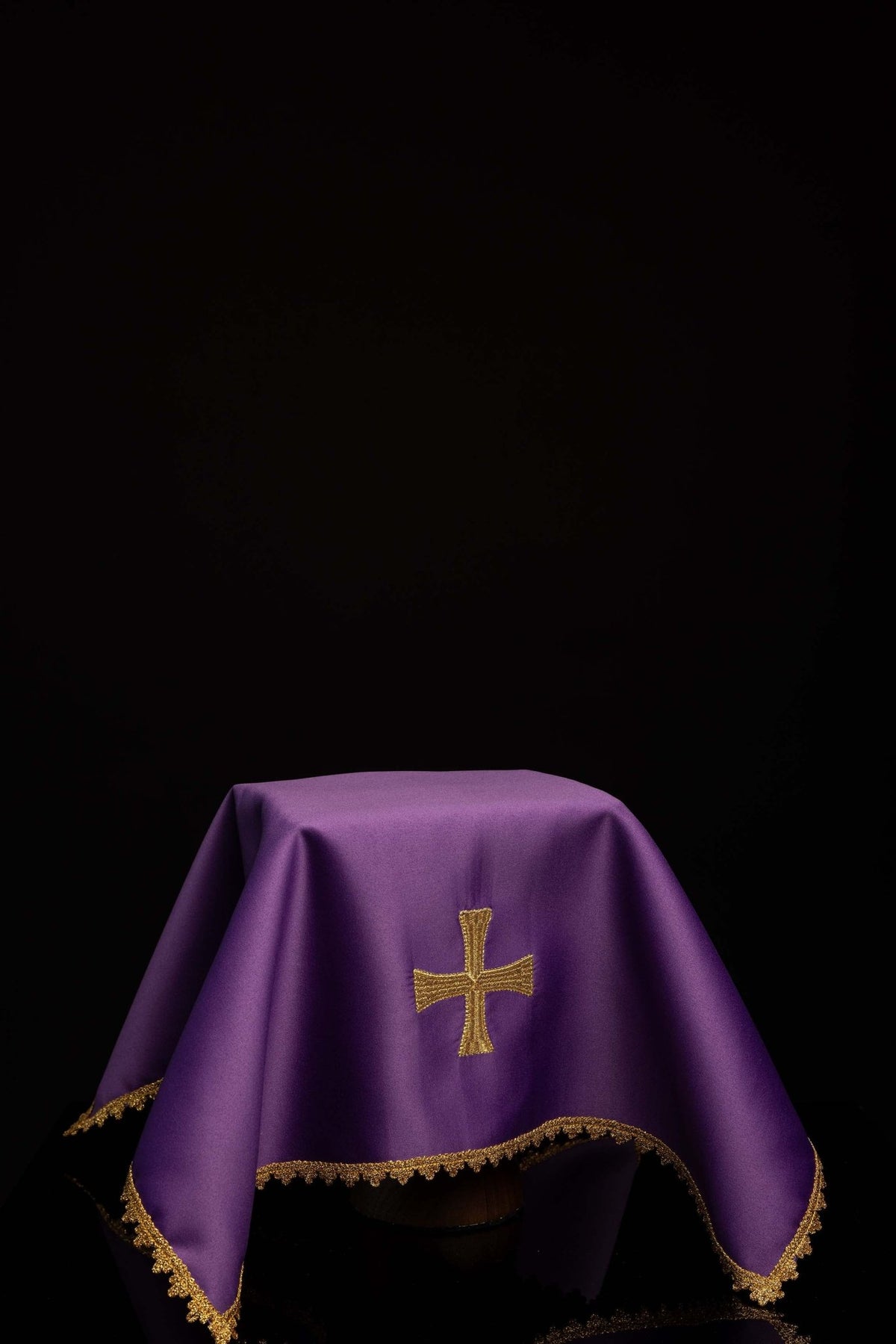 Worn purple chalice veil with gold cross embroidery and scalloped gold trim