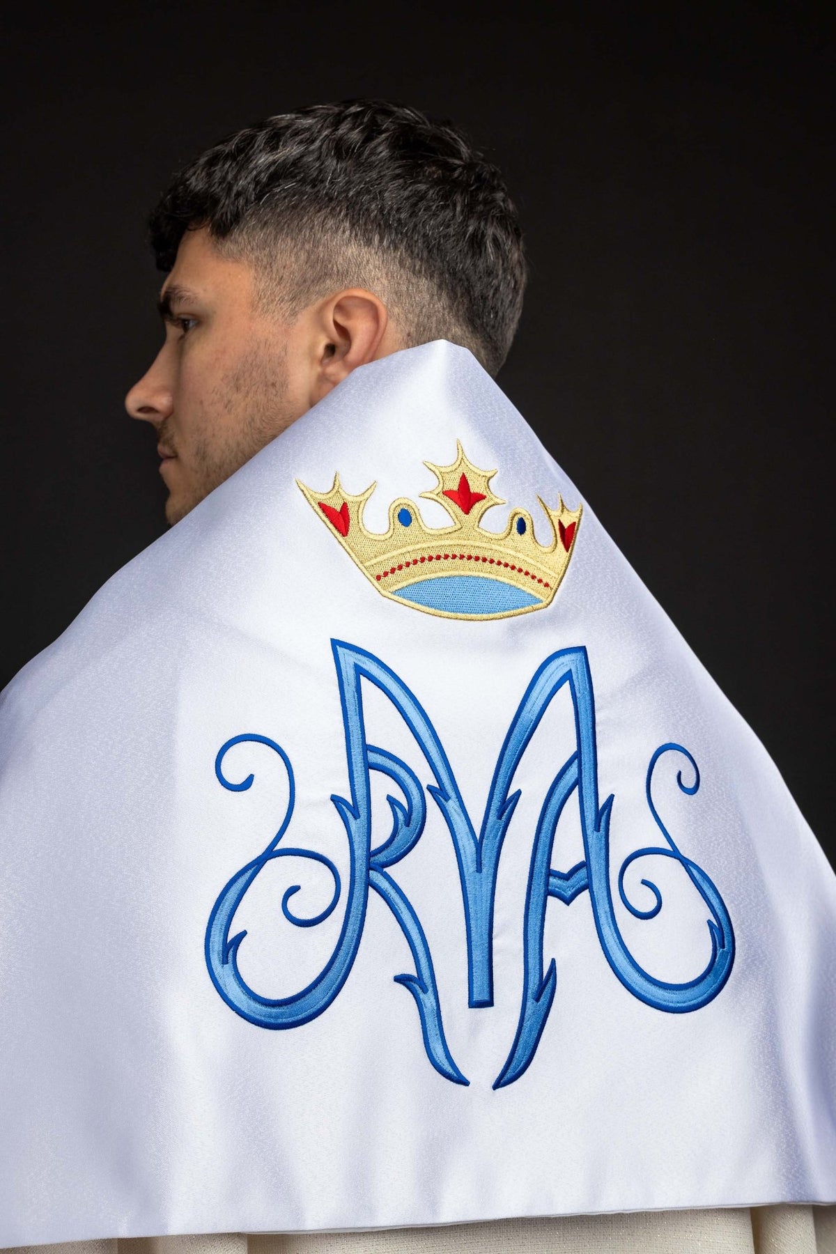 Worn back view of a White Humeral Veil with Embroidered Marian Symbol showing blue Marian monogram and crown